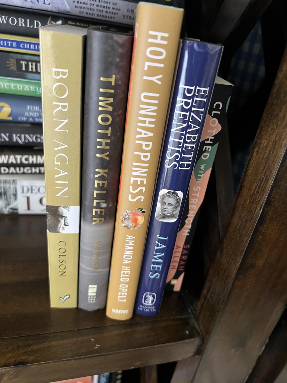 stack of Christian books on a shelf