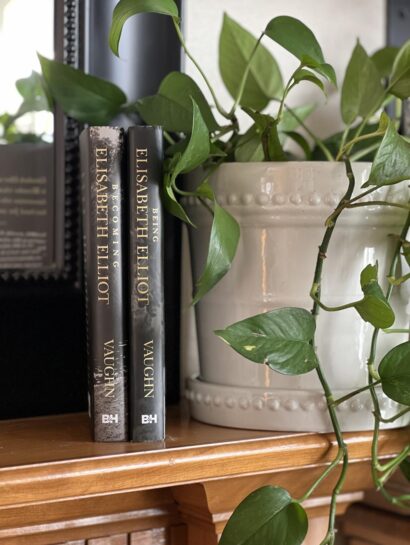 two Elisabeth Elliot books next to a plant on a mantel