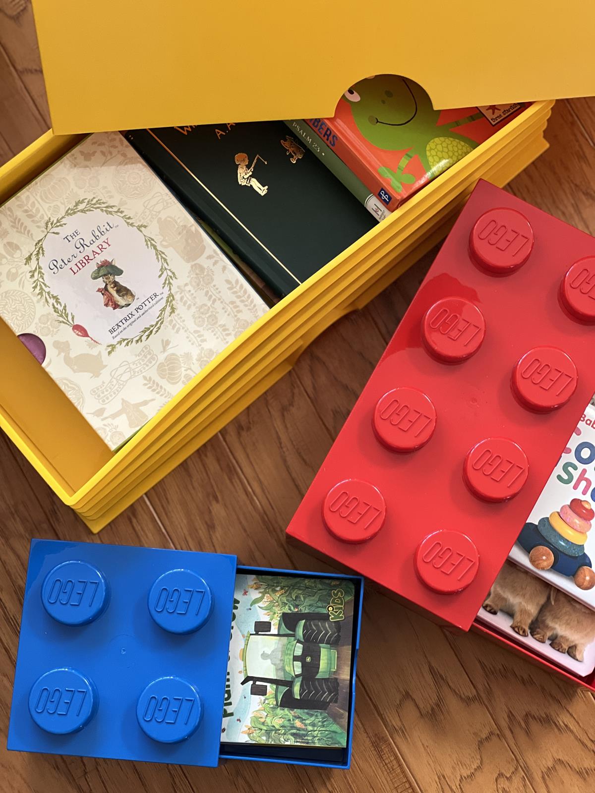 Lego storage boxes with kids books inside for a Lego book gift