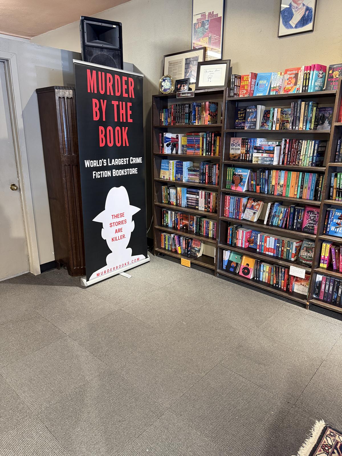 Murder By the Book sign and books