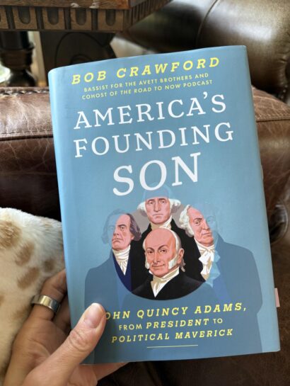 holding book American's Founding Son by Bob Crawford