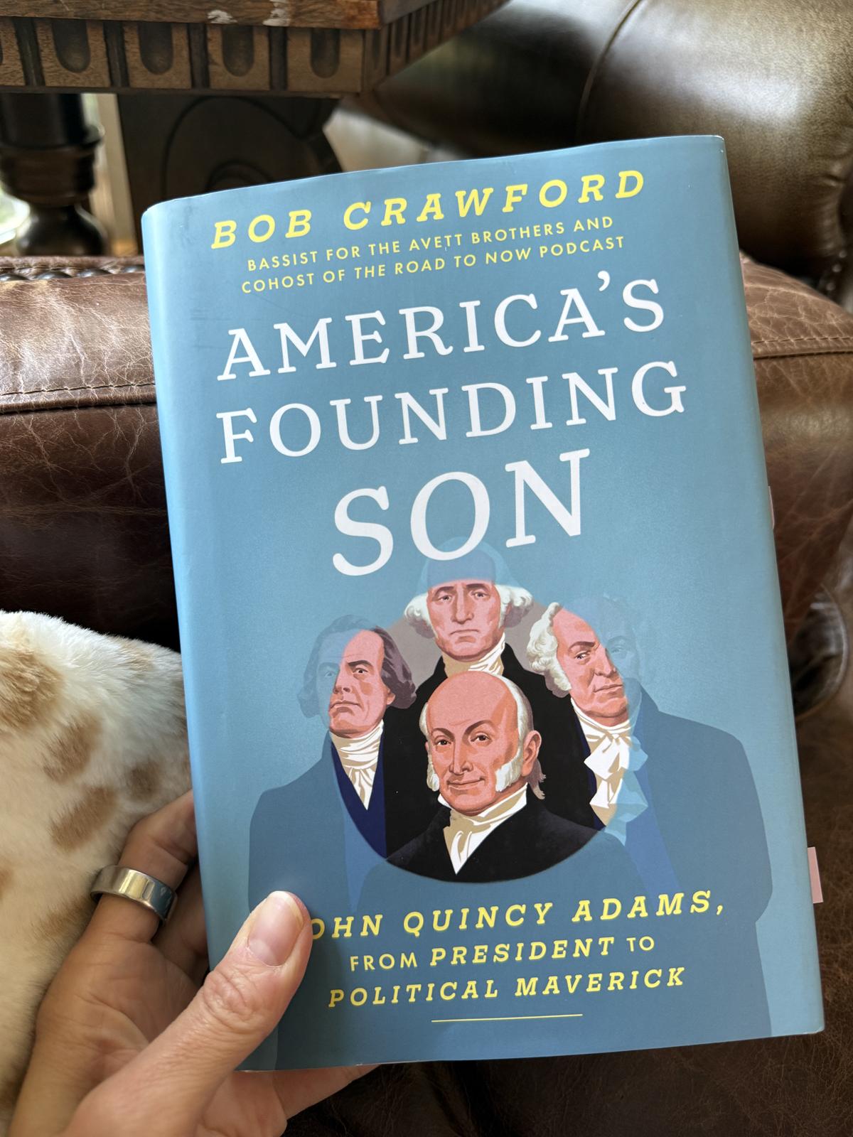 holding book American's Founding Son by Bob Crawford