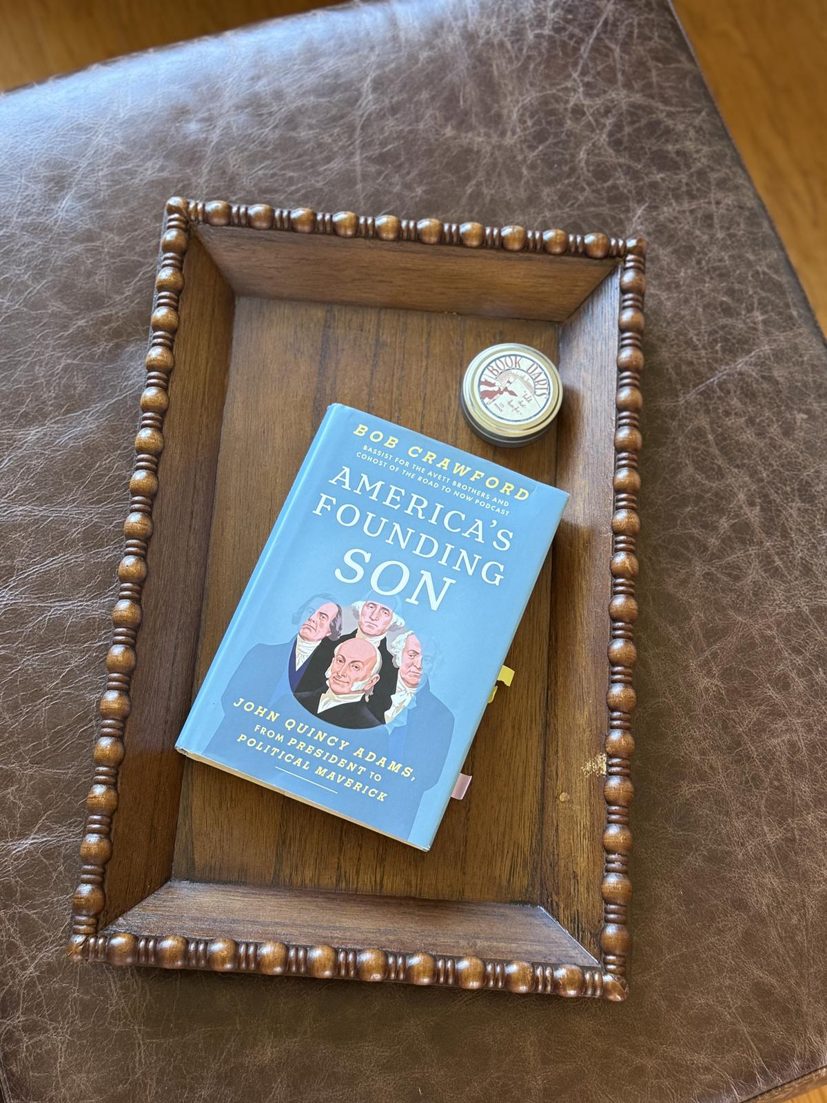American's Founding Son by Bob Crawford on wood tray on ottoman